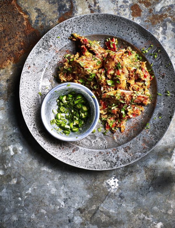 Food photography showing a plate with shredded mackerel seasoned with chopped chillies and coriander
