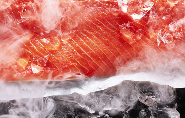 Food photography showing a close up of cold smoked salom still smoking.