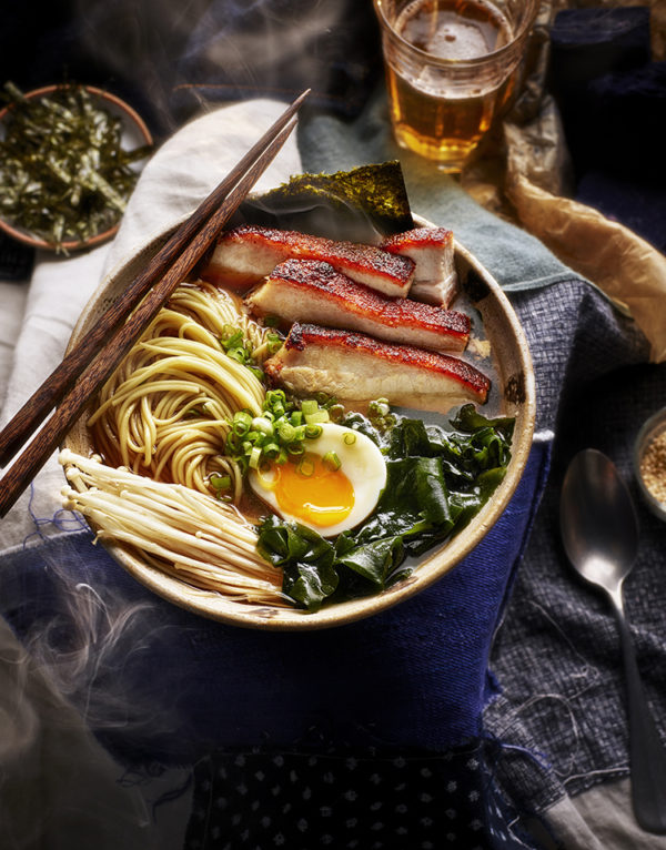 Food photographer London displays a bowl containing belly pork, noodles, half an egg and green vegetables
