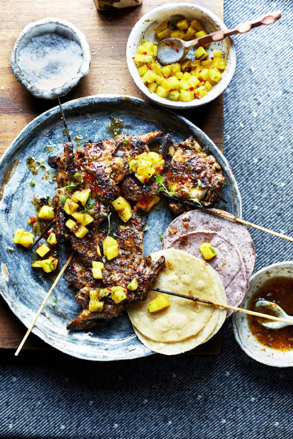 Food photgraphy showing skewered quail, with a spicy mango and habanero salsa