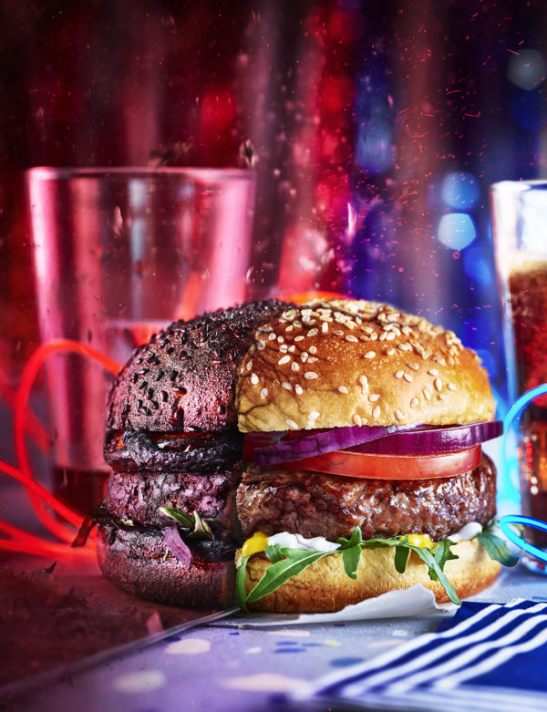 Food photographer London displaying a tradional burger in a bun topped with tomato and red onion, shown in half against a mirror to reference Stranger Things TV show