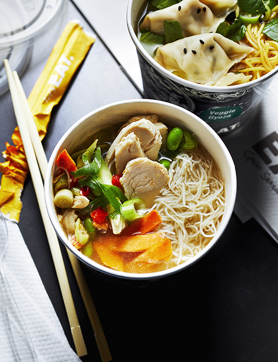 Food photography for advertising showing two different soups one with vegetable and noodles and the other with dumplings